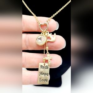 Gold tone religious charm necklace